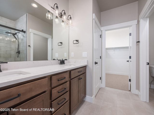 bathroom featuring tile patterned floors, walk in shower, and vanity