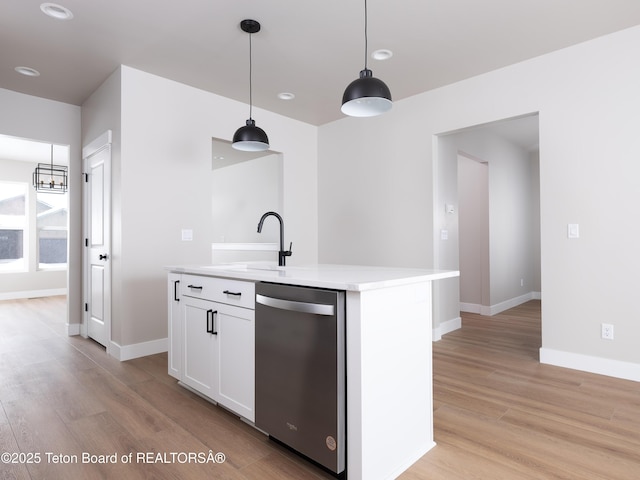 kitchen featuring white cabinetry, a center island with sink, decorative light fixtures, stainless steel dishwasher, and sink