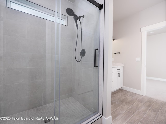 bathroom with an enclosed shower and vanity