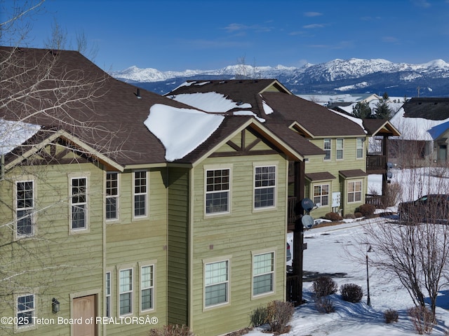 view of snow covered exterior with a mountain view