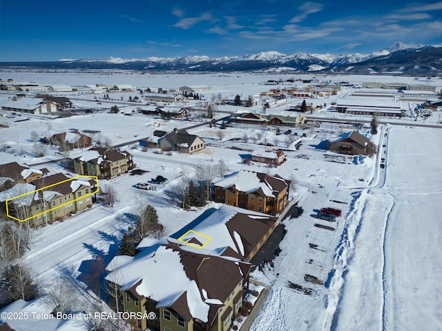 snowy aerial view with a mountain view