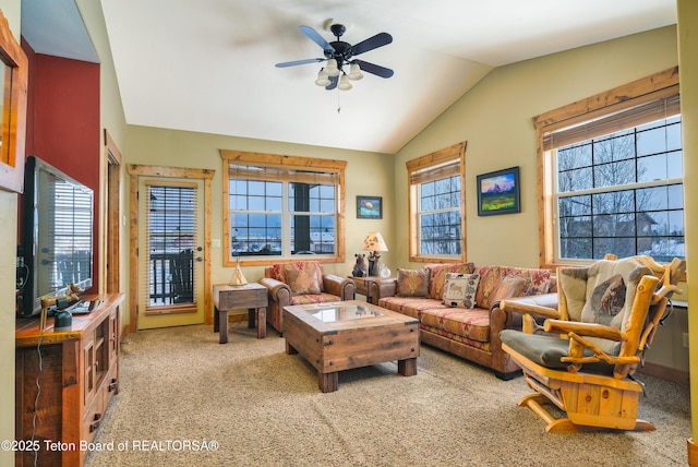 carpeted living room with vaulted ceiling and ceiling fan