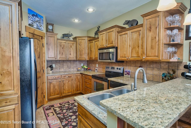 kitchen featuring light tile patterned flooring, appliances with stainless steel finishes, pendant lighting, backsplash, and light stone countertops