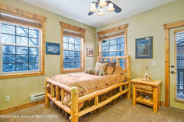 bedroom featuring multiple windows, a baseboard radiator, carpet flooring, and ceiling fan