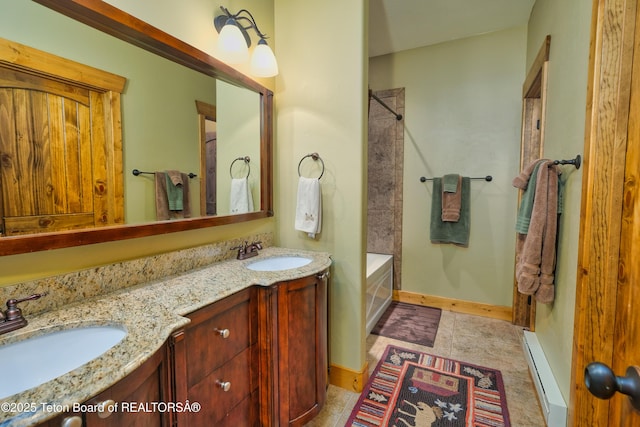 bathroom with a baseboard radiator, vanity, and tiled shower / bath combo