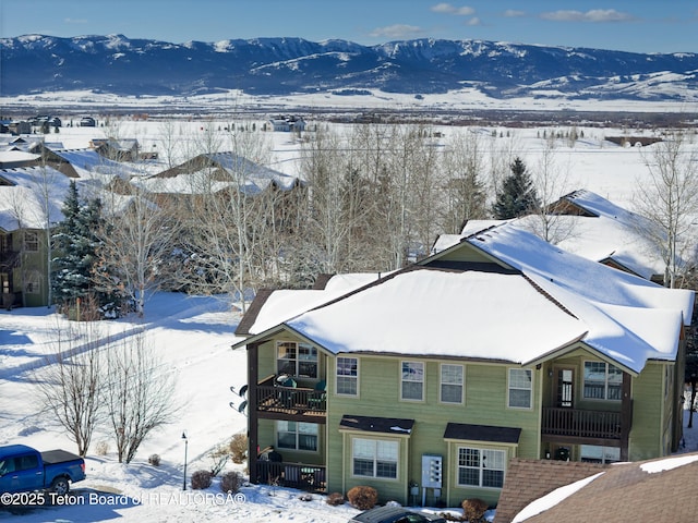 snowy aerial view featuring a mountain view