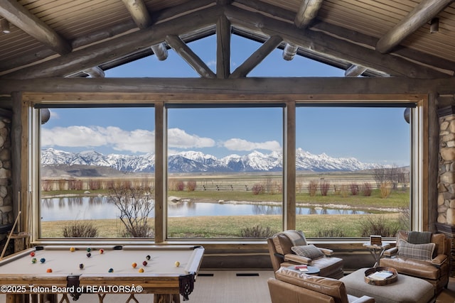 rec room with a water and mountain view, a rural view, and lofted ceiling with beams