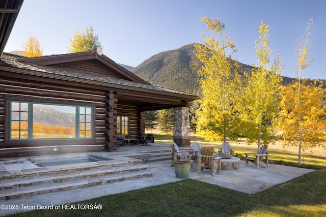 view of patio / terrace featuring a mountain view and an outdoor fire pit