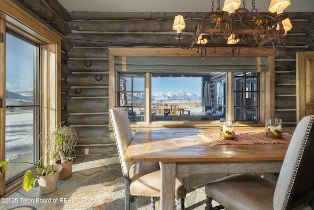 unfurnished dining area with a mountain view, rustic walls, and a chandelier