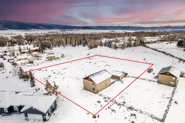 snowy aerial view featuring a mountain view