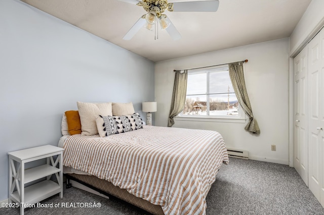 bedroom featuring dark colored carpet, ceiling fan, a closet, and a baseboard heating unit