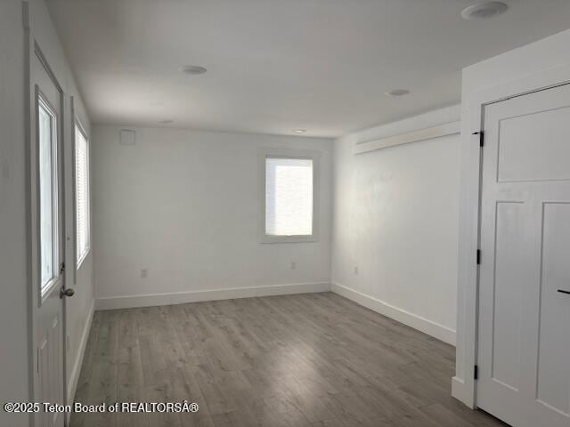 empty room with hardwood / wood-style floors