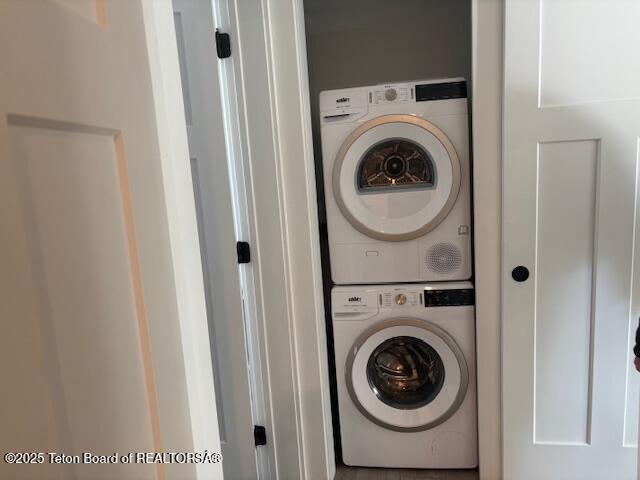 laundry room with stacked washer and dryer