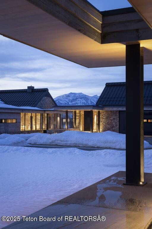 snow covered pool featuring a mountain view