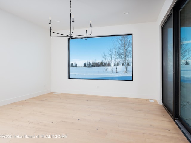 interior space featuring light hardwood / wood-style flooring and a chandelier