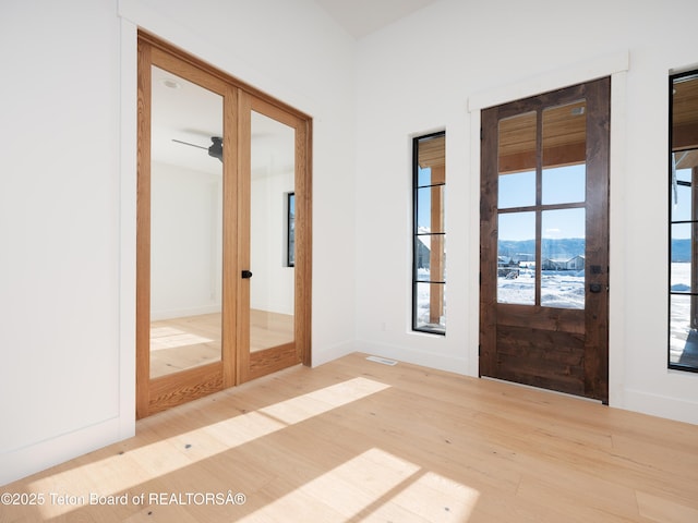 doorway with hardwood / wood-style flooring, a mountain view, and french doors