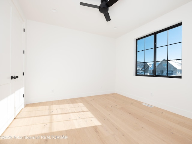 spare room featuring light hardwood / wood-style flooring and ceiling fan