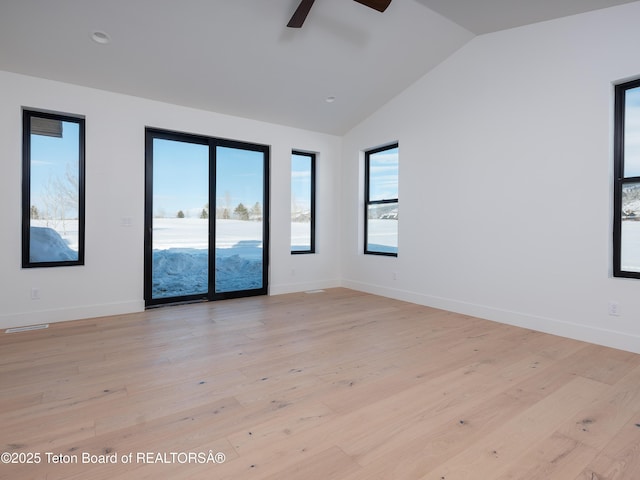 empty room featuring lofted ceiling, ceiling fan, and light wood-type flooring