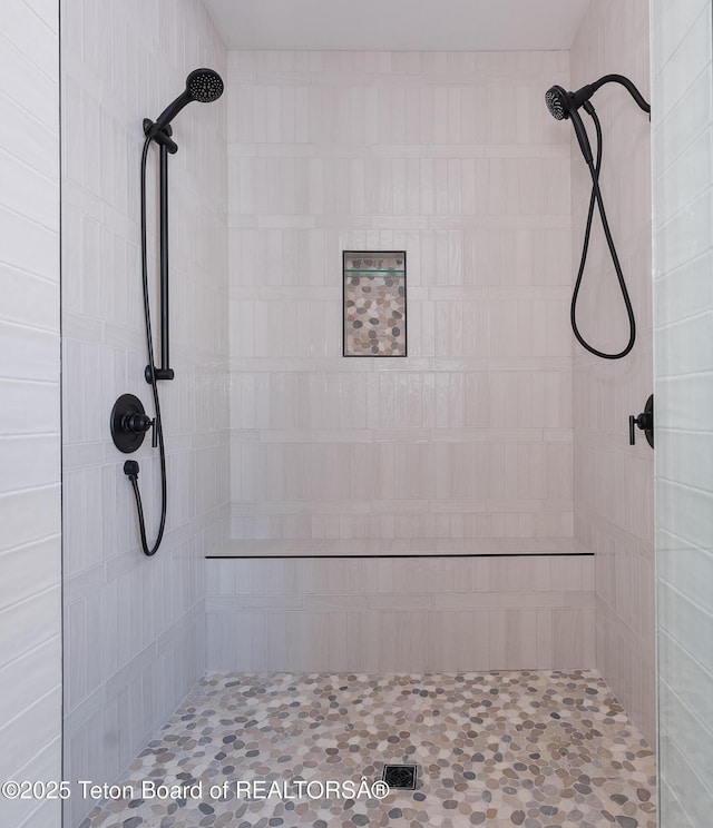 bathroom with tiled shower