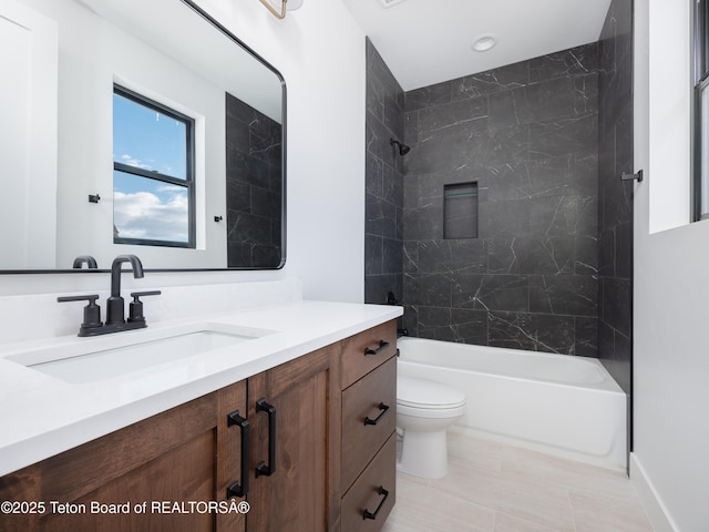 full bathroom featuring tiled shower / bath combo, vanity, and toilet