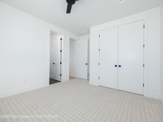 unfurnished bedroom with carpet floors, ceiling fan, and a closet