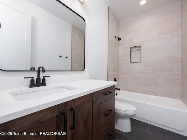 full bathroom with tiled shower / bath, vanity, and toilet