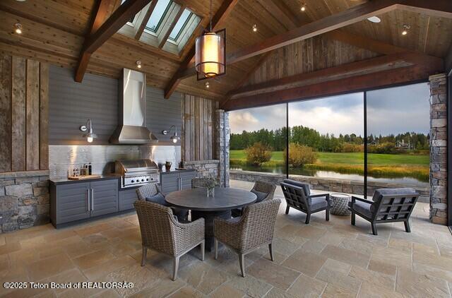 view of patio with area for grilling, a grill, and a gazebo