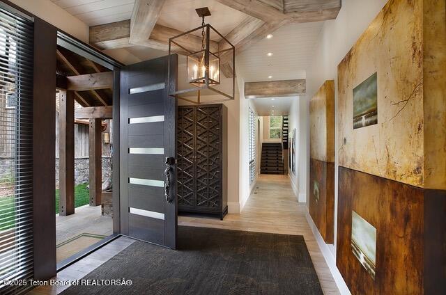 foyer entrance with an inviting chandelier and wood-type flooring