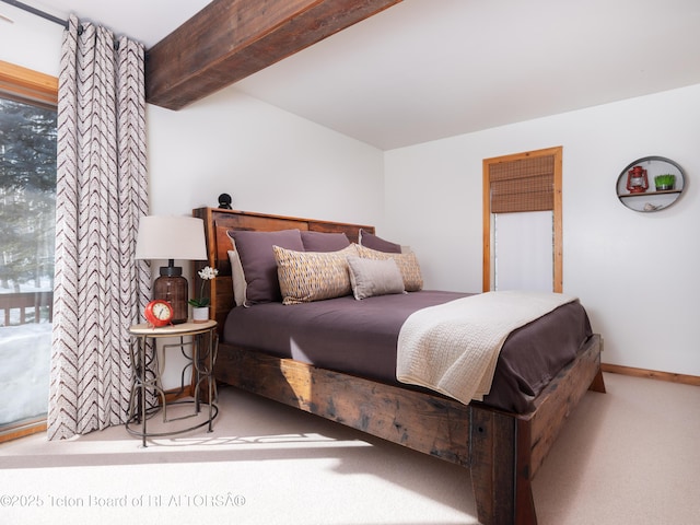 bedroom featuring beamed ceiling and light carpet