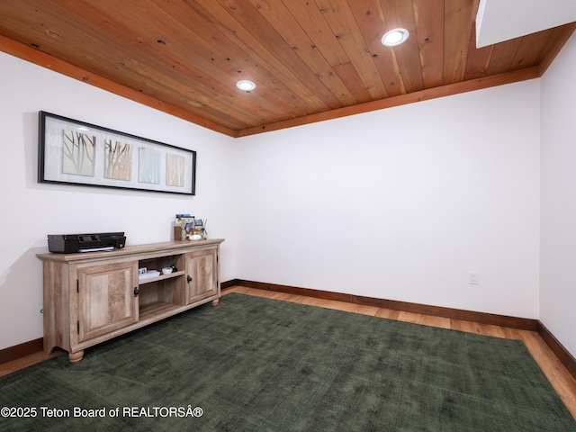 office space with ornamental molding, dark wood-type flooring, and wooden ceiling