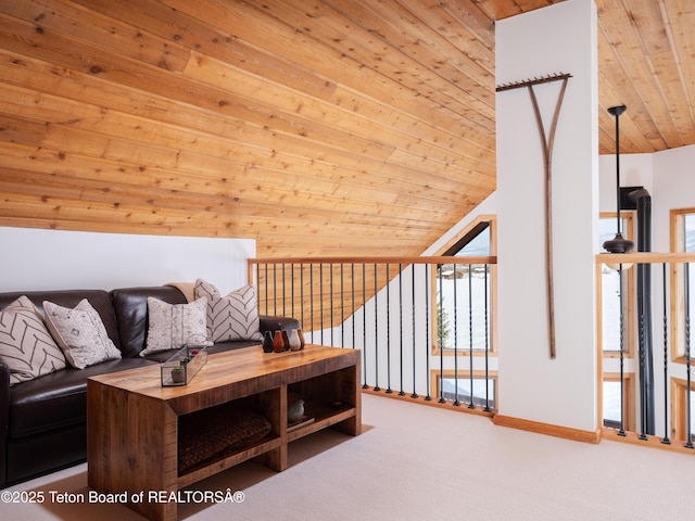 living room featuring vaulted ceiling, wooden ceiling, and carpet