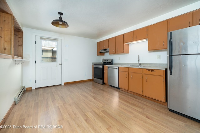 kitchen with sink, a textured ceiling, stainless steel appliances, light hardwood / wood-style floors, and a baseboard heating unit