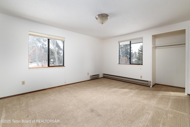 unfurnished bedroom featuring a baseboard radiator and carpet floors