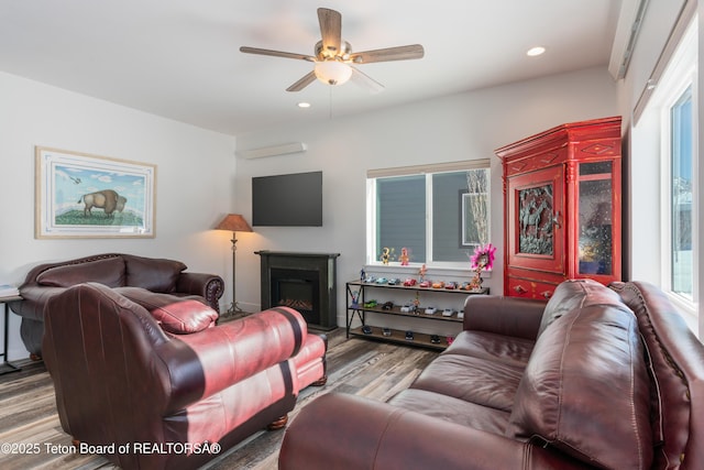 living room featuring ceiling fan and light wood-type flooring