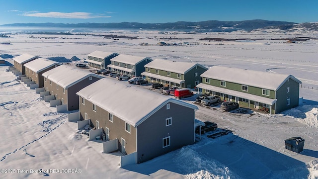 snowy aerial view with a mountain view