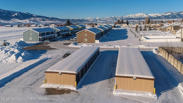 snowy aerial view featuring a mountain view