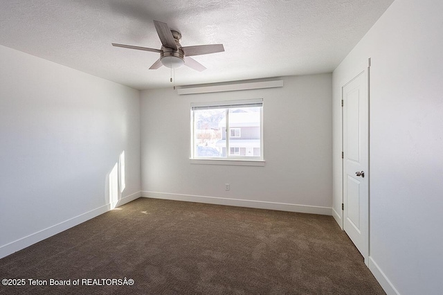 carpeted empty room with ceiling fan and a textured ceiling