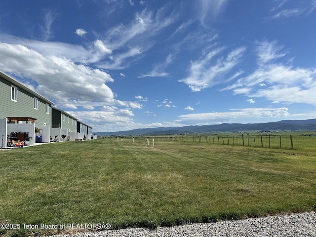 view of yard with a mountain view and a rural view