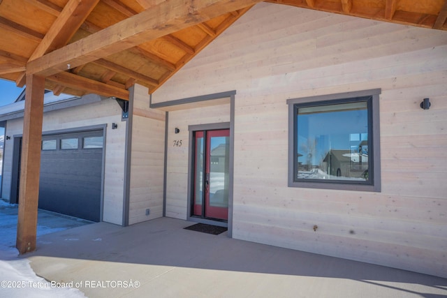 view of exterior entry with a garage