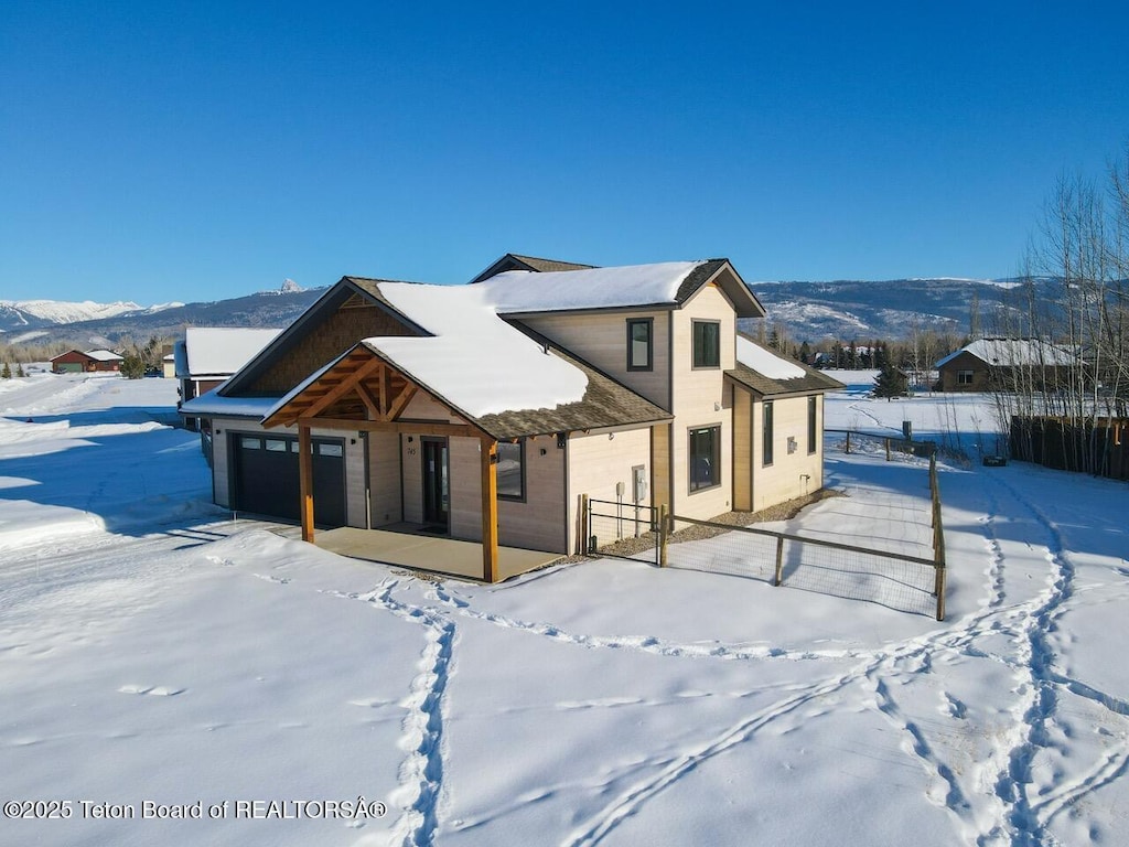 view of front of house featuring a mountain view and a garage