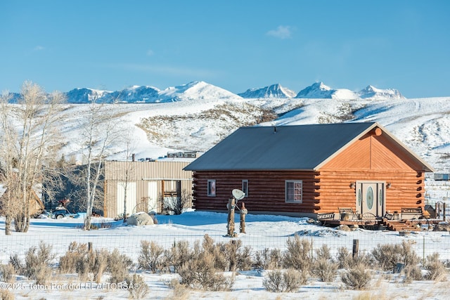 snow covered property featuring a mountain view