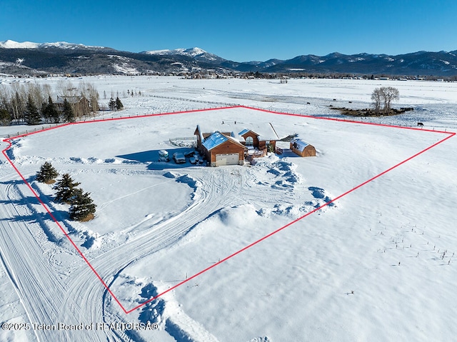 snowy aerial view with a mountain view