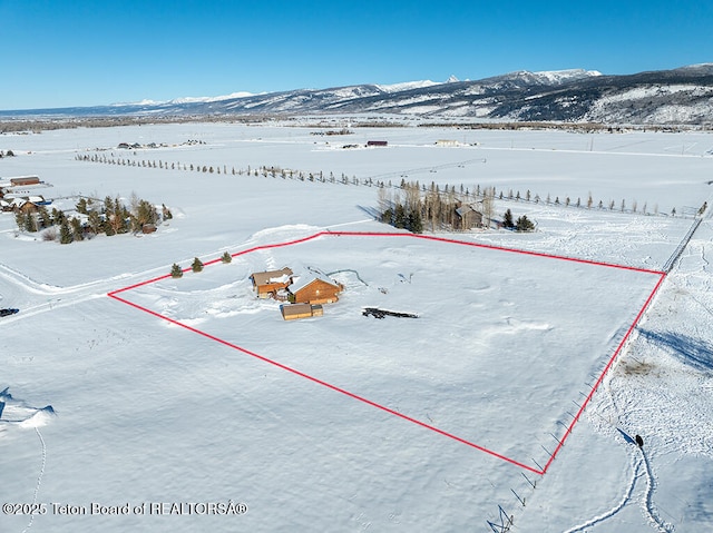 snowy aerial view featuring a mountain view