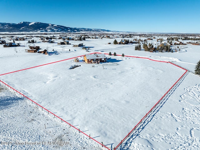 snowy aerial view with a mountain view