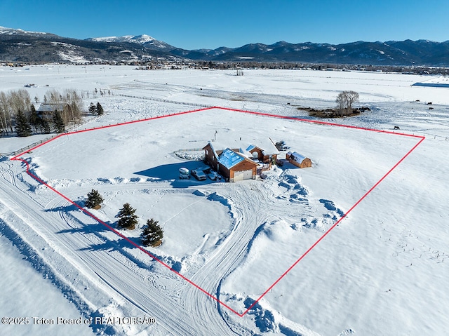 snowy aerial view featuring a mountain view