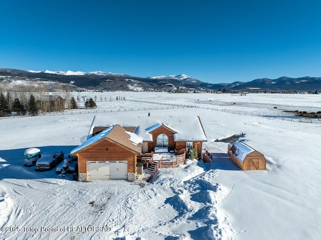 snowy aerial view with a mountain view