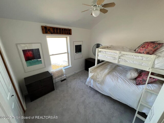 carpeted bedroom featuring lofted ceiling and ceiling fan