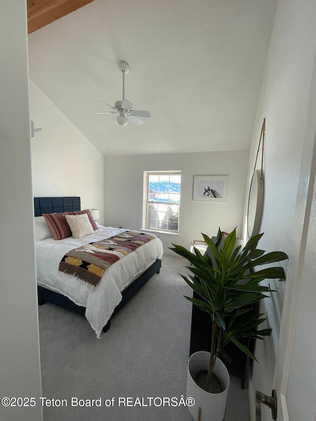 bedroom with ceiling fan, lofted ceiling, and carpet