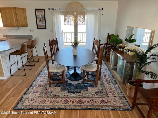 dining area featuring an inviting chandelier and light hardwood / wood-style floors