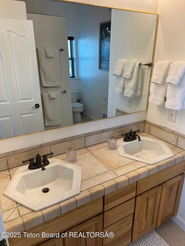 bathroom with vanity and toilet